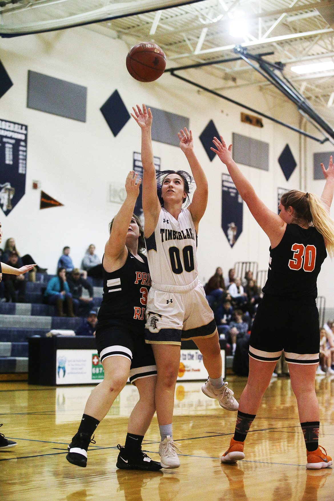 Timberlake&#146;s Karina Sande scores on a layup while defended by Priest River&#146;s Abby Shockey, left, and Adrie Minish during Monday&#146;s game at Timberlake High School.