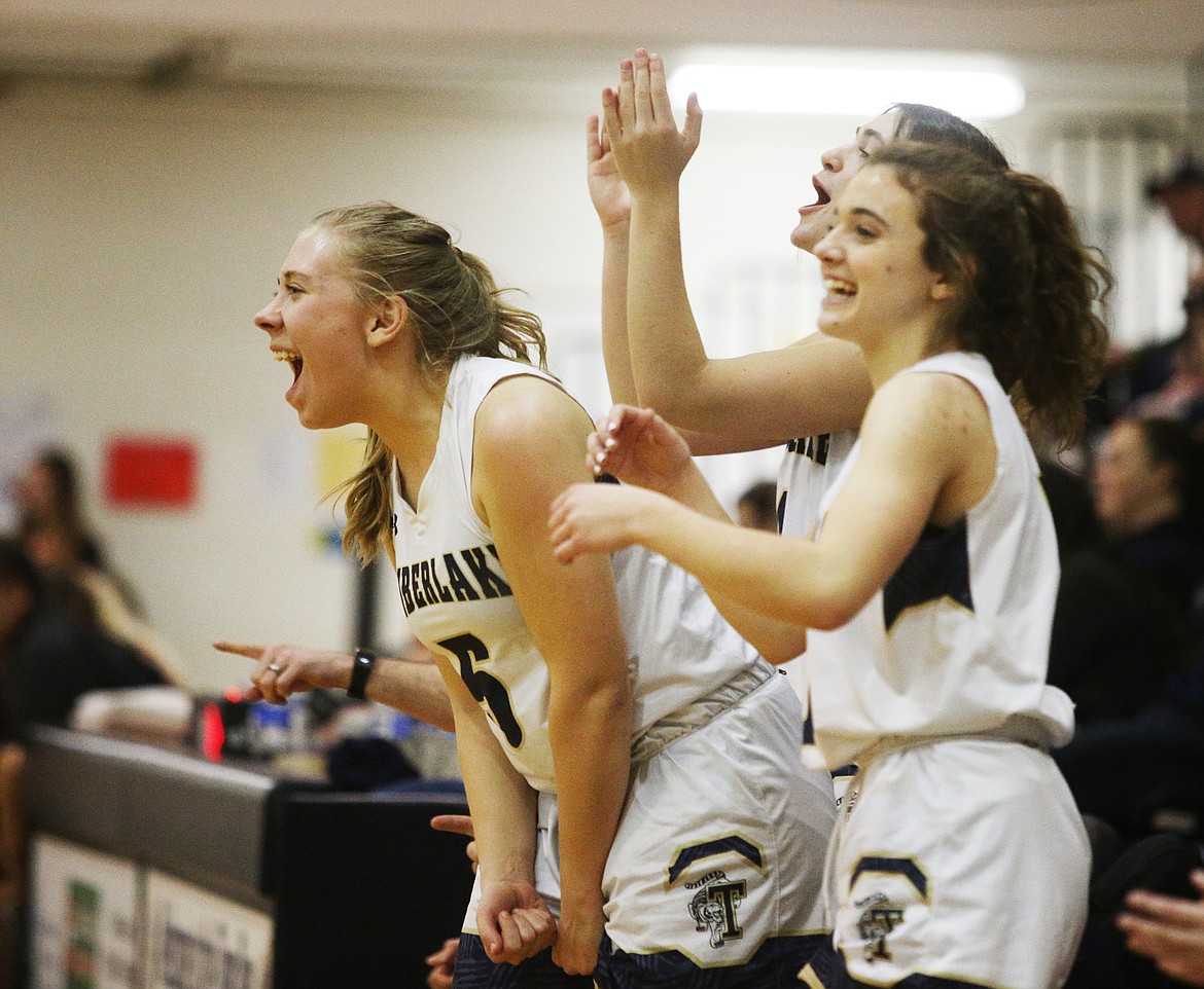 The Timberlake High School girls basketball bench erupts after a 3-pointer against Priest River.