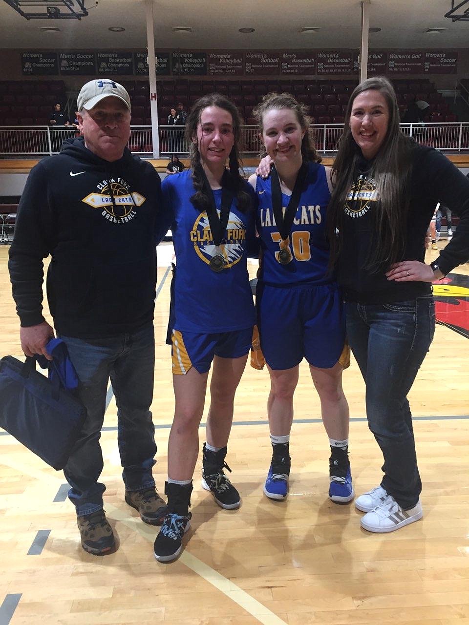 (Courtesy photo)
Clark Fork assistant coach Mark Stevens (left), Sara Hathaway, Ellie Kiebert and head coach Jordan Adams pose for a photo after the two seniors received North Star League honors last Thursday.