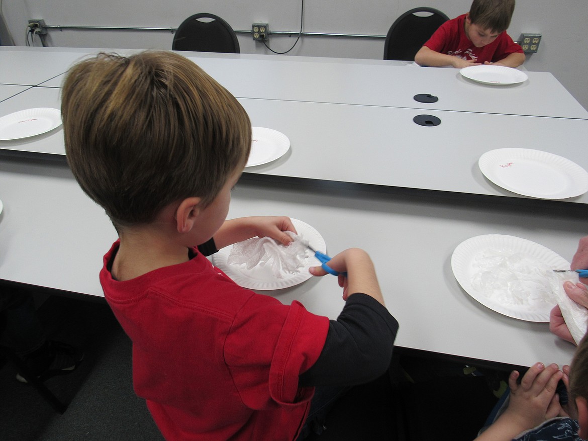 (Courtesy photo)An Idaho Hill Elementary kindergartner works on a &quot;Snow White Mystery Science&quot; project making snow flakes as part of a STEaM activity at the school recently.