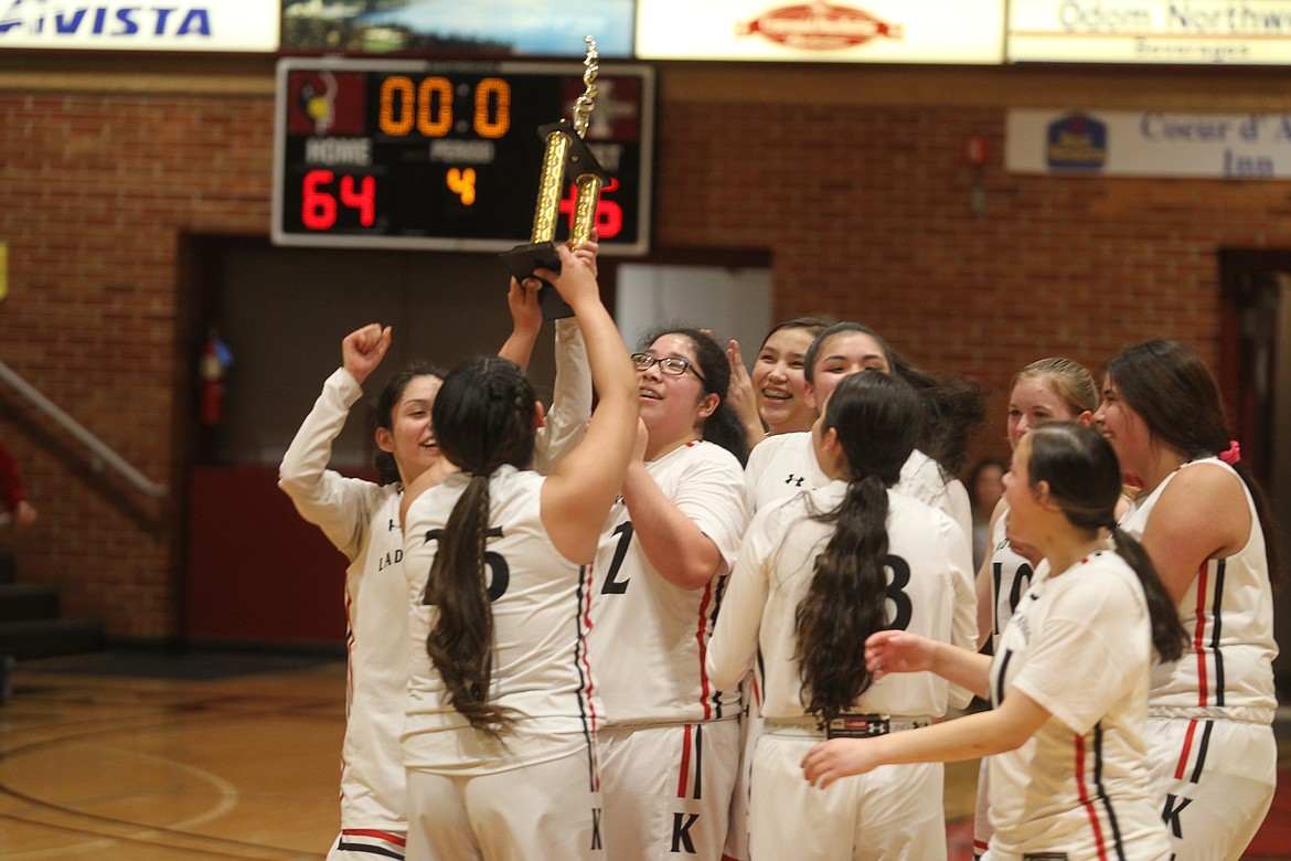 Members of the Lakeside High girls basketball team celebrate a 64-46 win Clark Fork in the 1A Division II District 1 championship game at center court on Rolly Williams Court on Thursday.

JASON ELLIOTT/Press