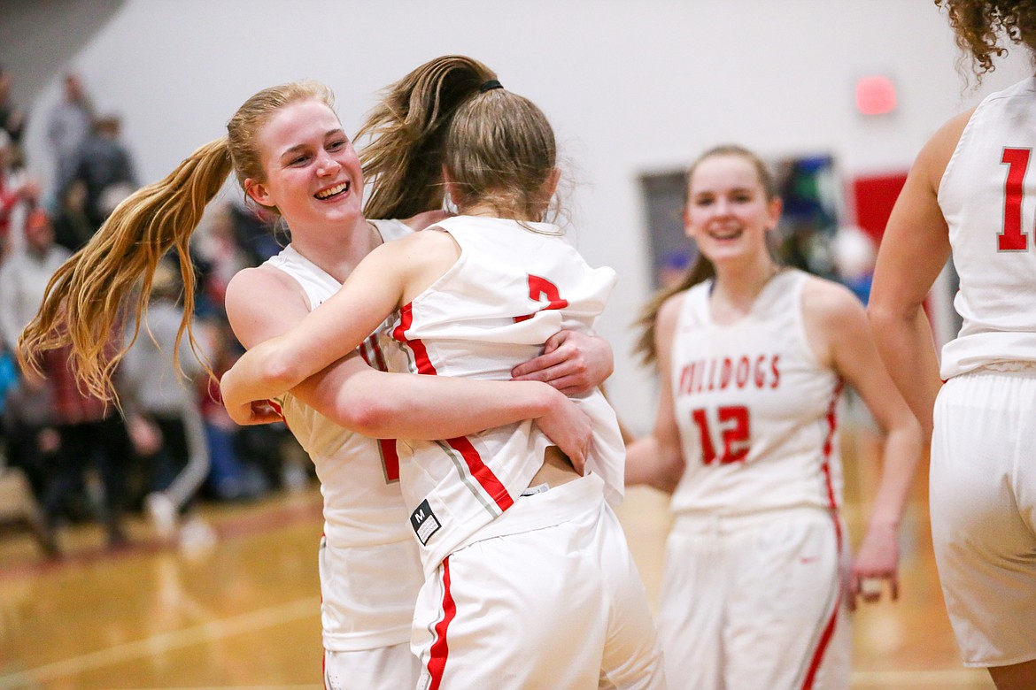 (Photo courtesy of JASON DUCHOW PHOTOGRAPHY)
Sophomore Sophia Platte (left) hugs freshman Daylee Driggs after the Bulldogs won Game 2 of the 4A Region 1 championship series over Lakeland on Friday.