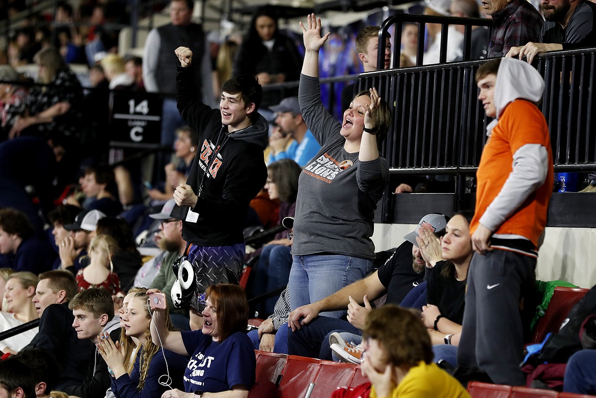 Heather Dunn, center, and other Eureka fans cheer on wrestler Pancho Ibenez during his match against Leeann Hoch of Shepherd in the 103-pound Class B-C first round match at the state wrestling tournament at First Interstate Arena on Friday. (Casey Page/Billings Gazette)