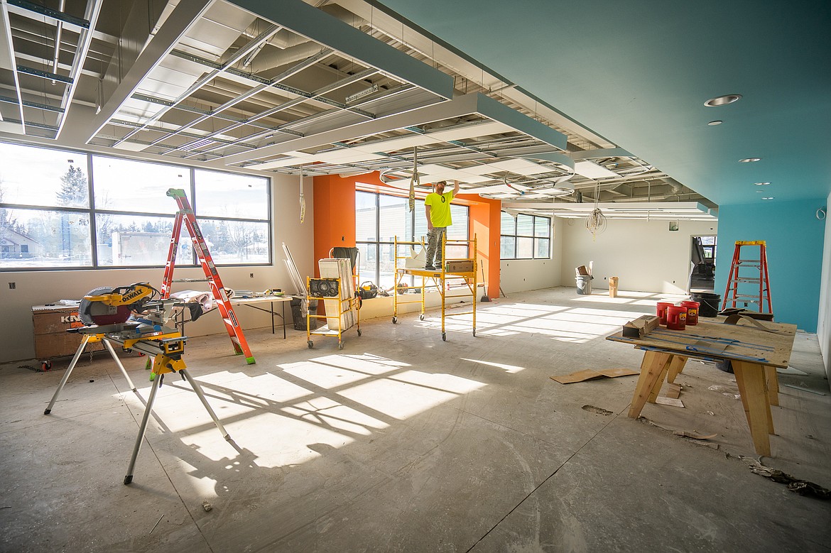 A worker installs ceiling panels in the library of the new Muldown Elementary School. (Daniel McKay/Whitefish Pilot)