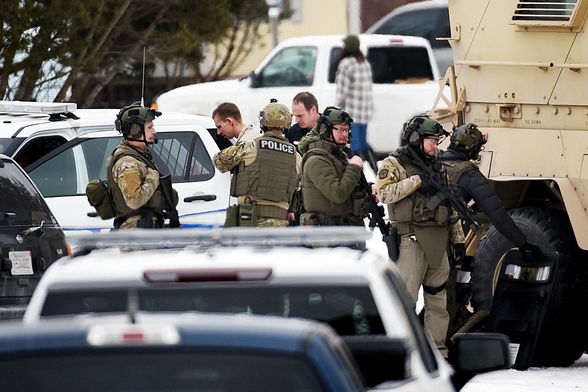 SWAT members and police place a suspect into custody during an alleged standoff in a mobile home park off Whitefish Stage Road in Kalispell on Wednesday, Feb. 12. (Casey Kreider/Daily Inter Lake)