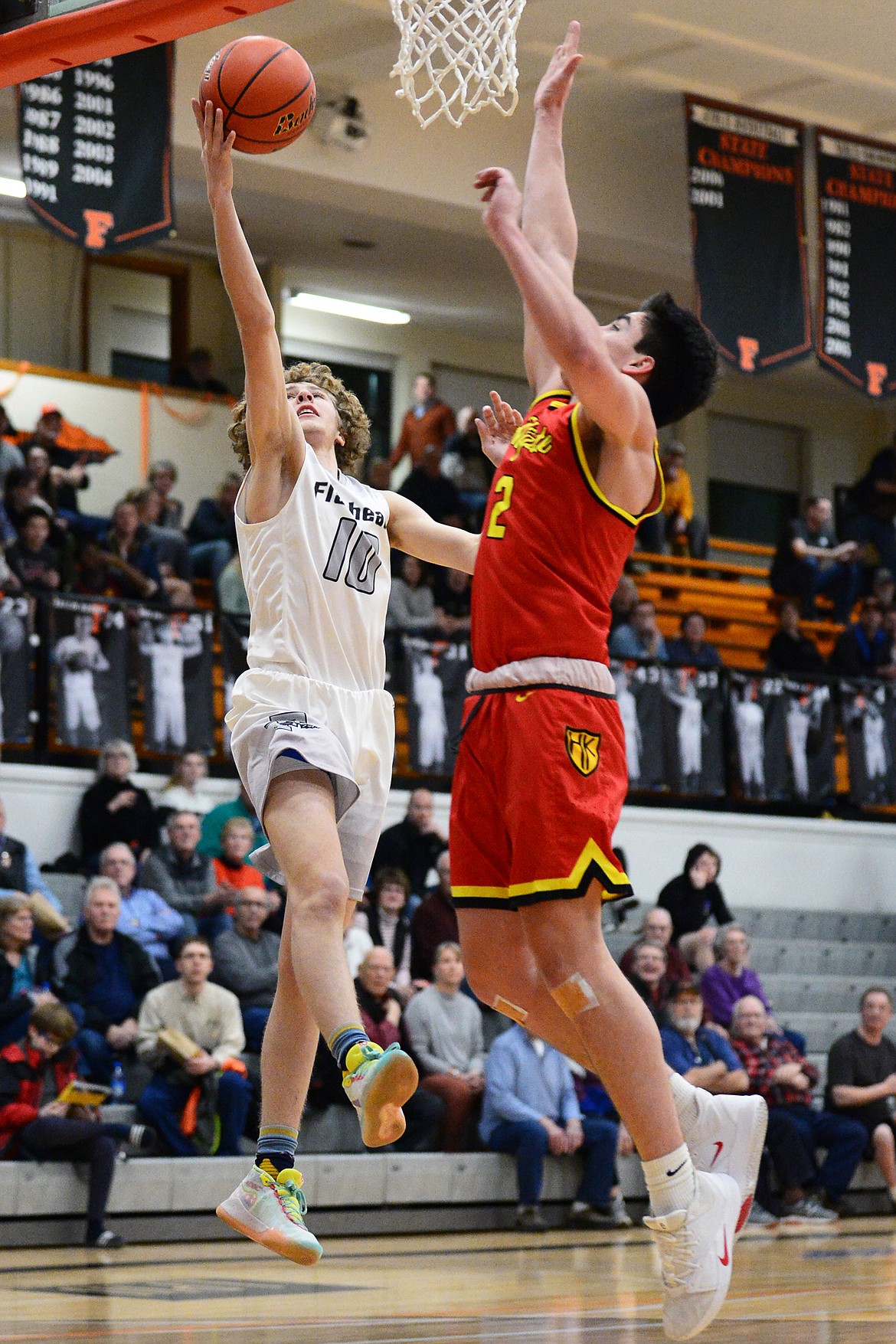 Flathead's Hunter Hickey (10) drives to the basket against Missoula Hellgate's Cam LaRance (2) at Flathead High School on Tuesday. (Casey Kreider/Daily Inter Lake)