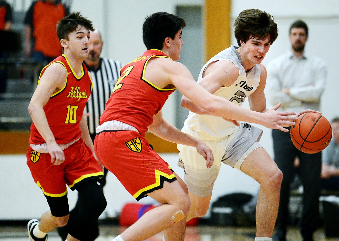 Flathead's Cooper Smith (20) brings the ball upcourt against Missoula Hellgate's full-court press at Flathead High School on Tuesday. Defending for Hellgate are Brandon Coladonato (10) and Cam LaRance (2). (Casey Kreider/Daily Inter Lake)