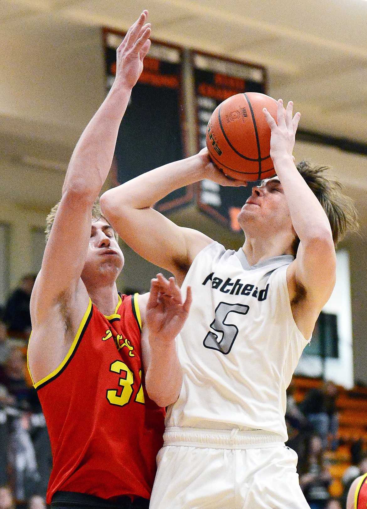 Flathead's Tannen Beyl (5) drives to the hoop against Missoula Hellgate's Abe Johnson (34) at Flathead High School on Tuesday. (Casey Kreider/Daily Inter Lake)