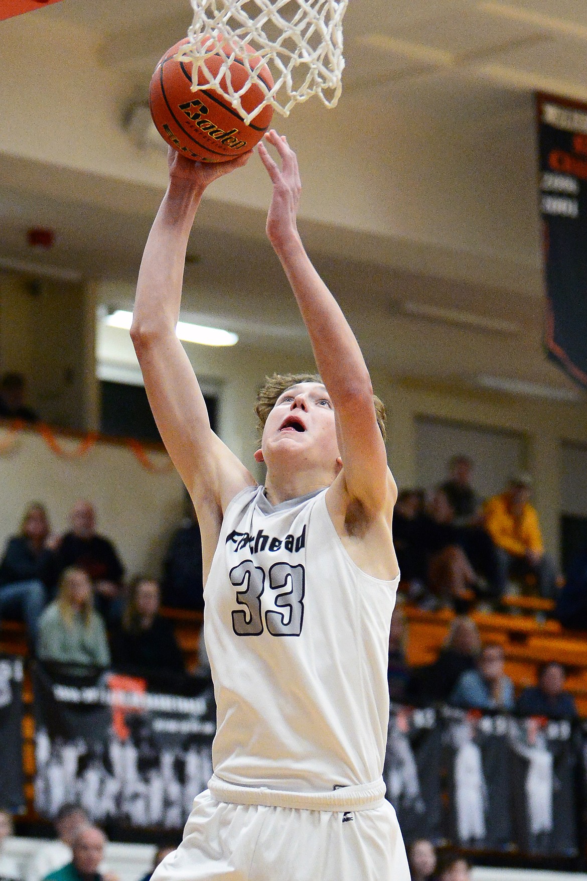 Flathead's Ezra Epperly (33) drives to the hoop for a layup against Missoula Hellgate at Flathead High School on Tuesday. (Casey Kreider/Daily Inter Lake)