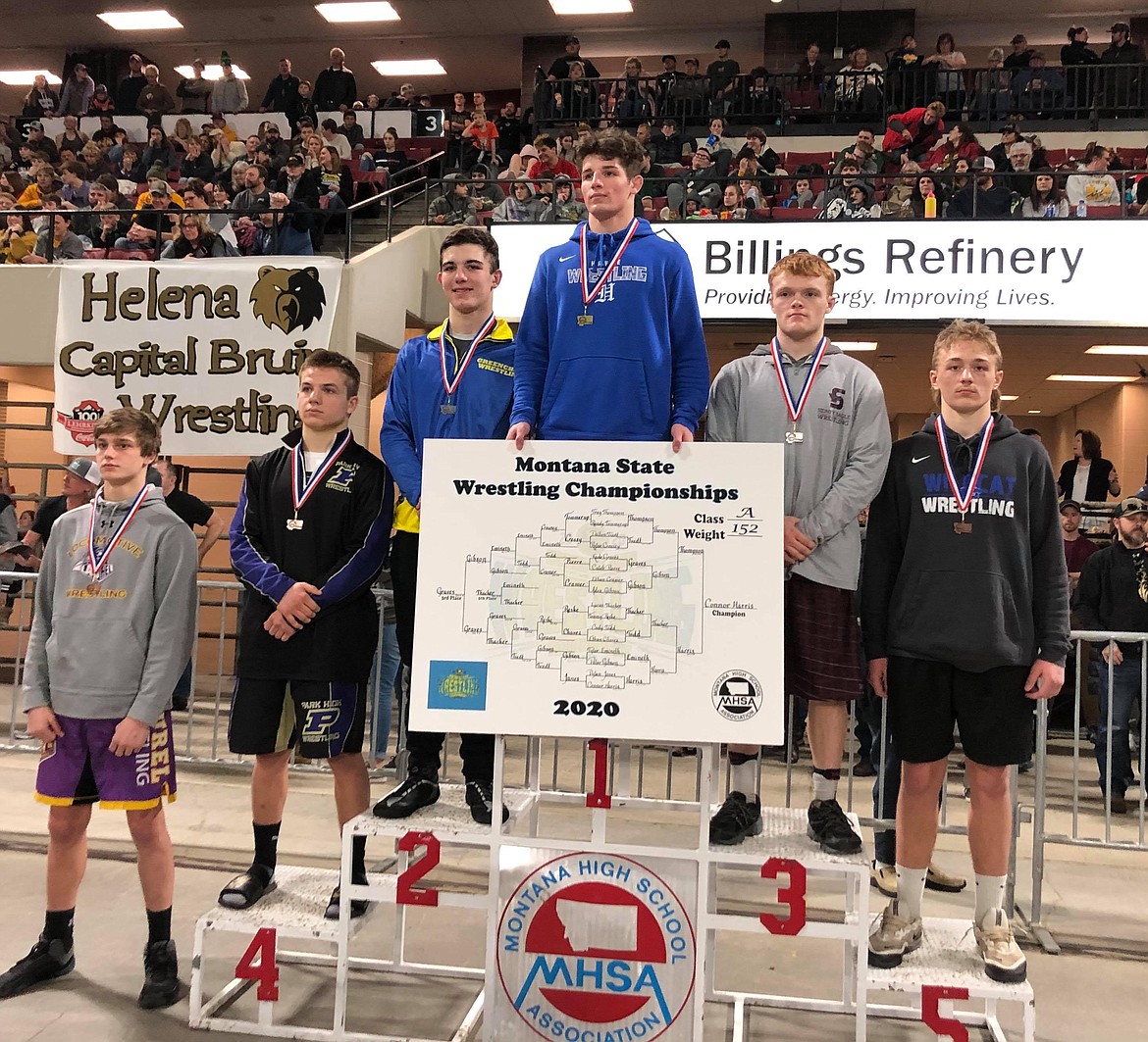 Trey Thompson stands on the podium after earning a second place finish in the 152-pound class. Below, Thompson squares off with a competitor during the two-day state tournament.  (Lyn Thompson for The Western News)