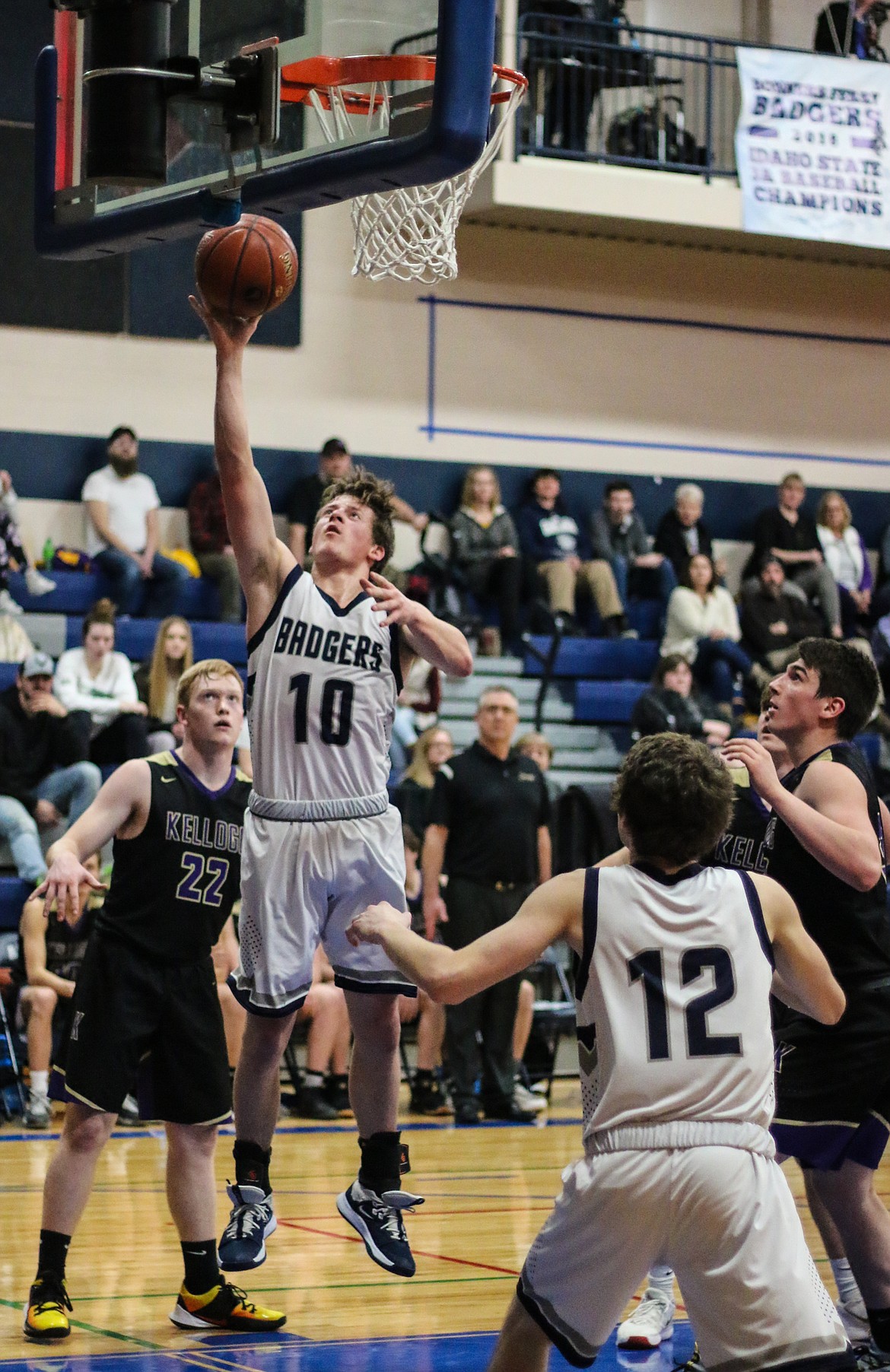 Left: Ty Bateman drives to the basket during last Thursday&#146;s game against Kellogg. The visiting Wildcats won 73-55.

Right: Matt Morgan leaps over Wildcat defenders.

Photos by MANDI BATEMAN