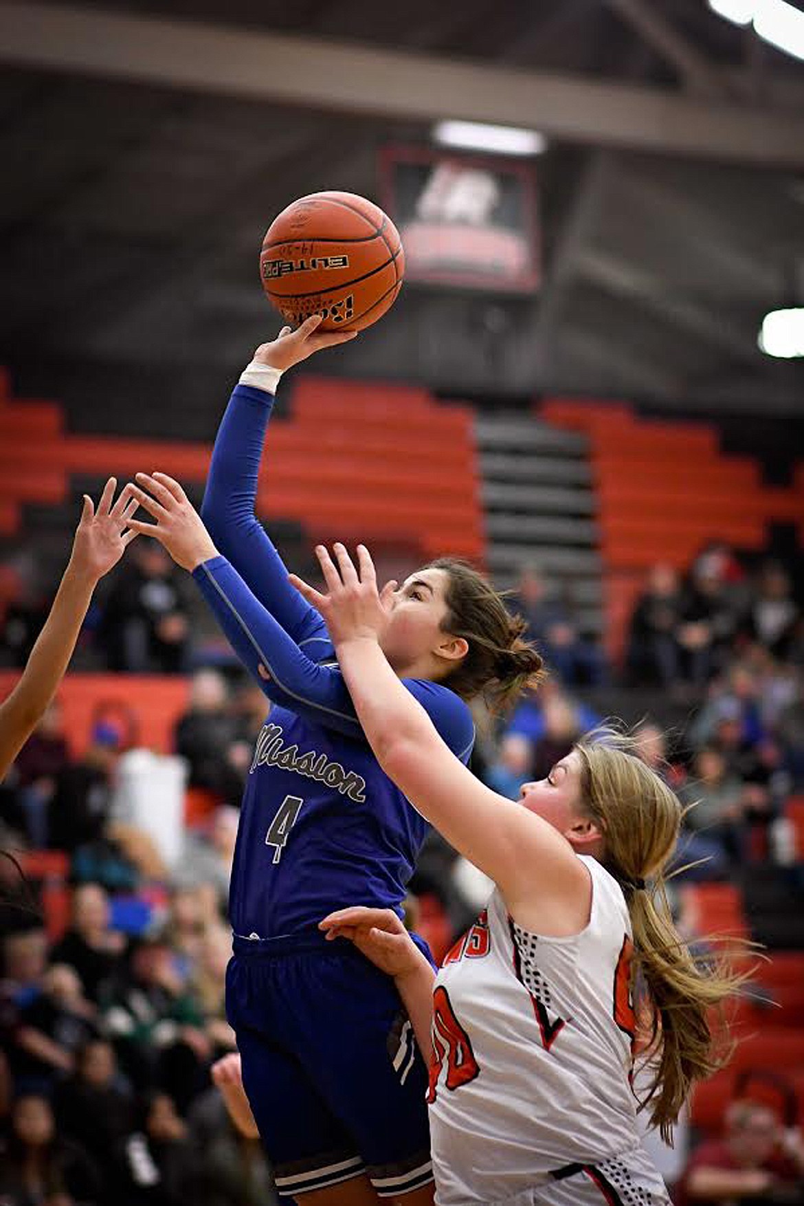 Mission's Azia Umphrey (4) goes up over Ronan's Jaylea Lunceford (40) during a recent game. Last week, Umphrey scored a total of 44 points to help the Lady Bulldogs to wins over Florence and Arlee. (File photo by Christa Umphrey)