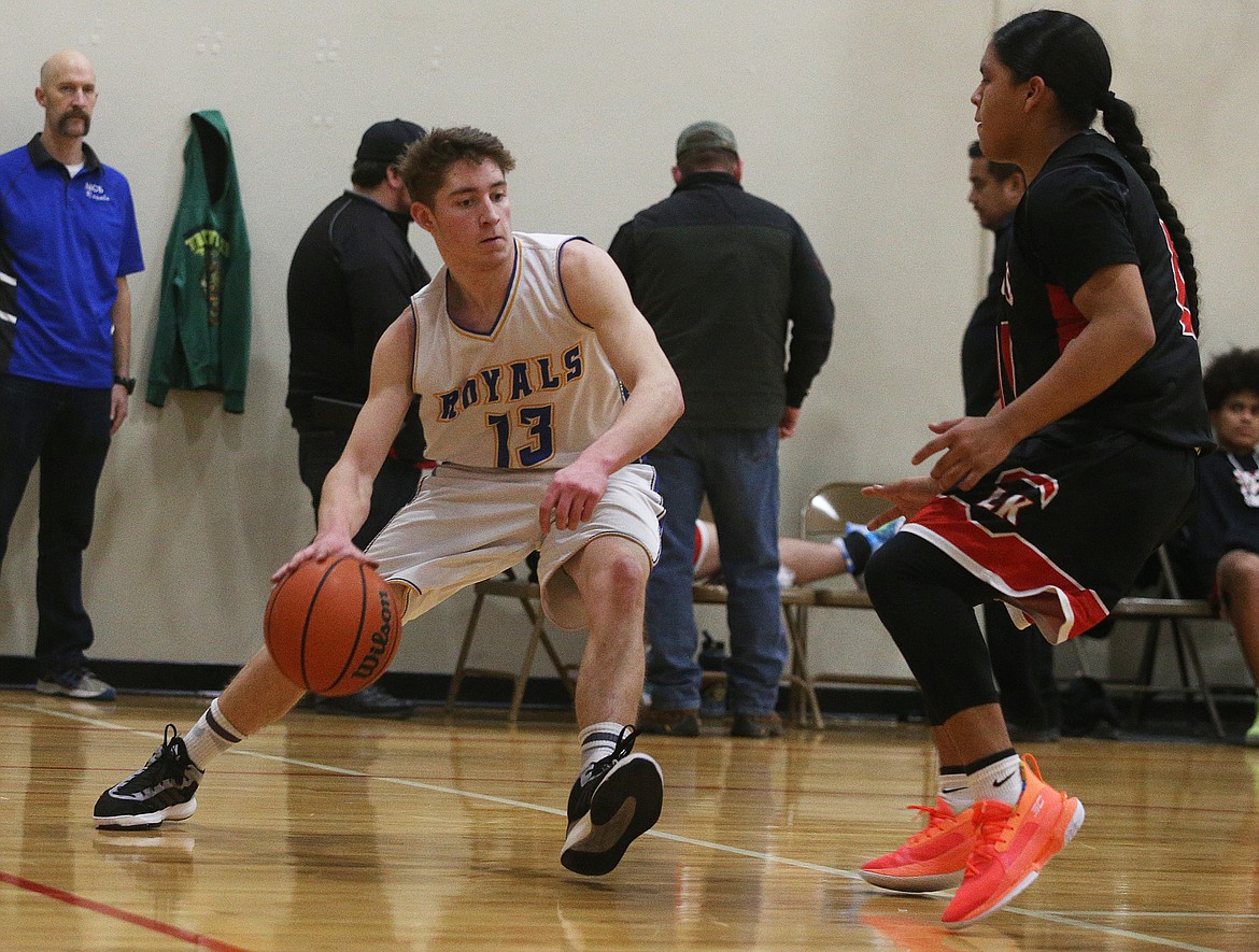 North Idaho Christian&#146;s Phil Connelly dribbles the ball toward the basket during last Monday&#146;s game at Holy Family Catholic School.