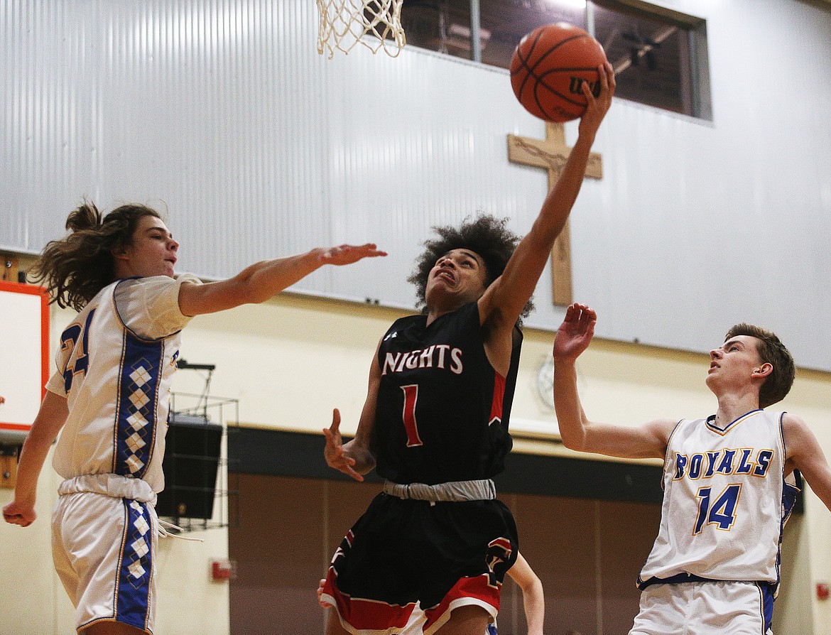 Lakeside&#146;s Vander Brown scores a layup between North Idaho Christian defenders during last Monday&#146;s game at Holy Family Catholic School in Coeur d&#146;Alene.