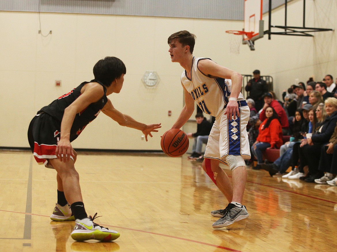 North Idaho Christian&#146;s Jake Peterson dribbles the ball as Lakeside&#146;s Kenyon Spotted Horse defends.