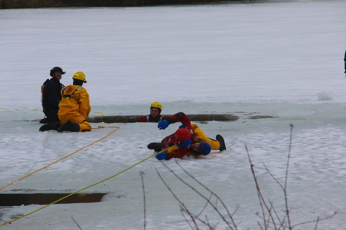 Photo by MANDI BATEMAN 
Being pulled to shore after a successful mock rescue out of the water.