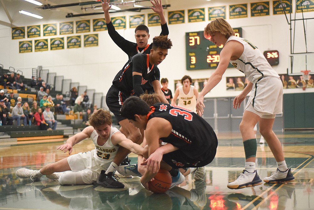 Justin Conklin dives for a loose ball during the Bulldogs' home loss last Tuesday. (Daniel McKay/Whitefish Pilot)