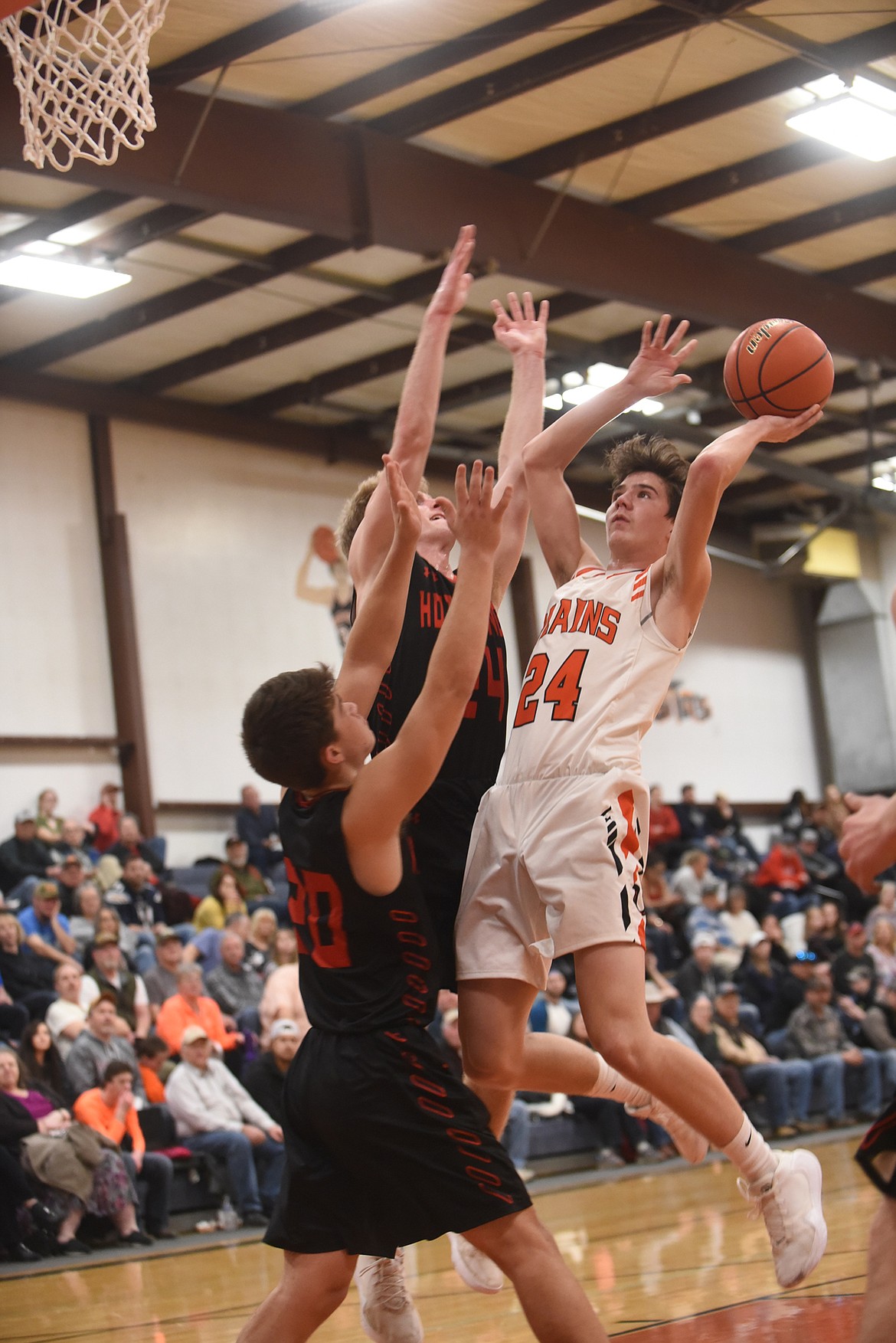 Plains senior Kade Pardee (24) tries to score against Hot Springs&#146; Brandon Knudsen (20) and Luke Waterbury (24) during their game Feb. 6. (Scott Shindledecker/Valley Press)