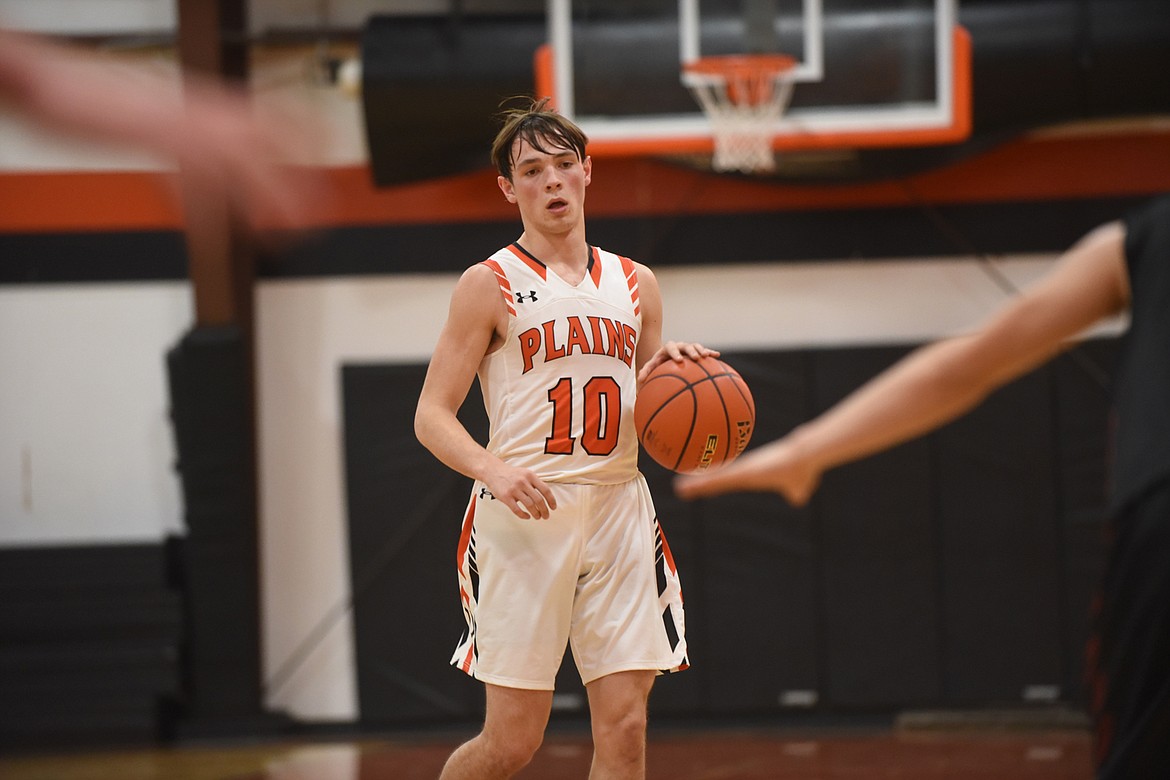 Plains senior Treydon Brouillette (10) dribbles upcourt against Hot Springs in a Feb. 6 game against Hot Springs. He scored 21 points to lead the Horsemen to a win. (Scott Shindledecker/Valley Press)