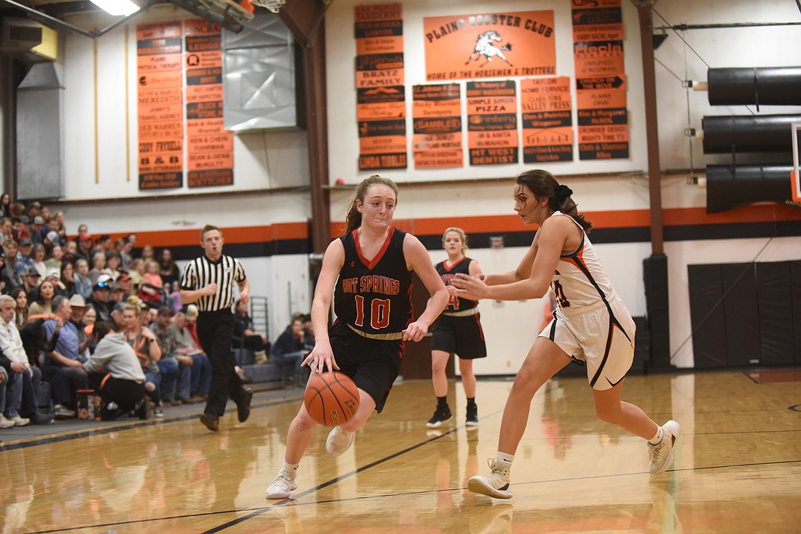 Hot Springs sophomore Katelyn Christensen (10) drives to the basket despite the defense of Plains senior Miera Loberg. (Scott Shindledecker/Valley Press)