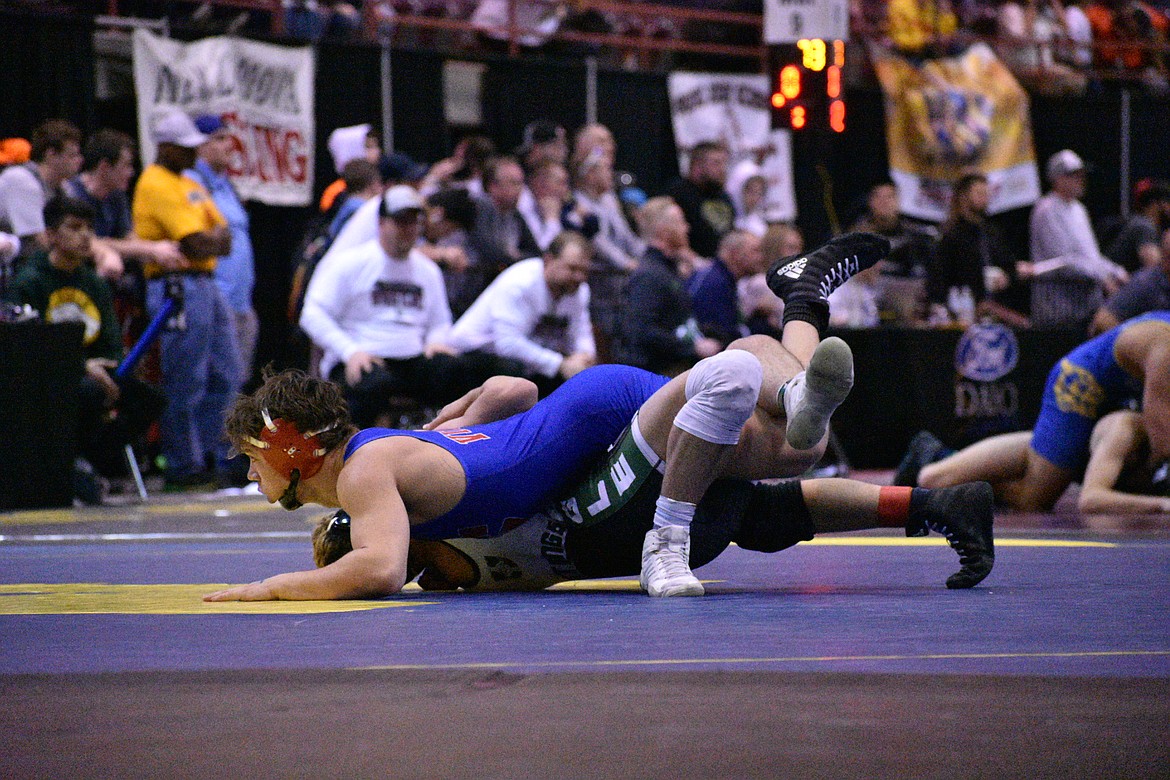 MOLLY MASON/Special to The Press
Nolan Randles of Coeur d&#146;Alene looks to pin Tyson Jones of Eagle in their state 5A 152-pound quarterfinal match Friday at the Ford Idaho Center in Nampa. Randles won 13-8.