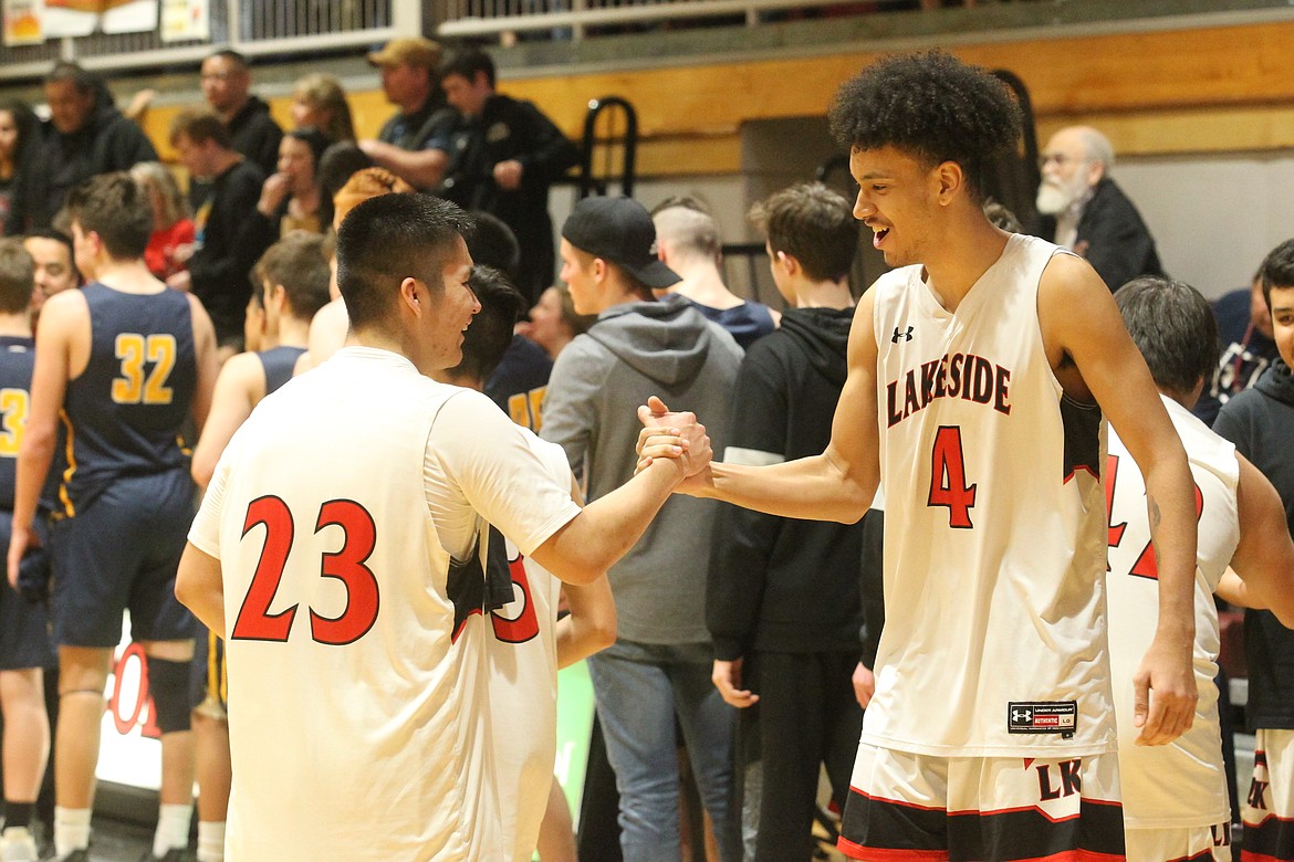 MARK NELKE/Press
Talon Twoteeth, left, and Darren &#147;Day Day&#148; Higgins of Lakeside celebrate after beating Genesis Prep to win the 1A Division II District 1 boys basketball championship Thursday night at North Idaho College.