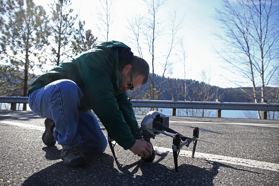 Don Taylor attaches a camera to his DJI Martice 210 drone before a flight demonstration at Higgens Point. (LOREN BENOIT/Press)