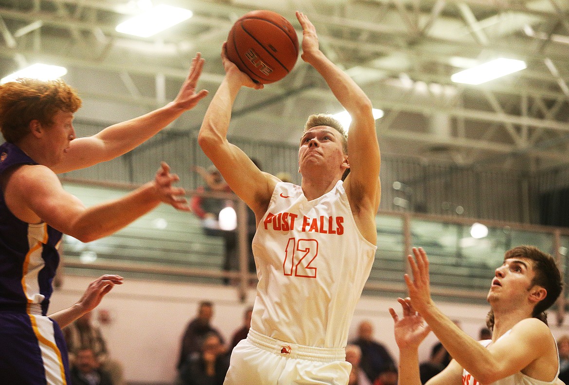 LOREN BENOIT/Press 
Post Falls High&#146;s Isaac Ballew goes for a layup against Lewiston in the 5A Region 1 championship game Wednesday at The Arena.