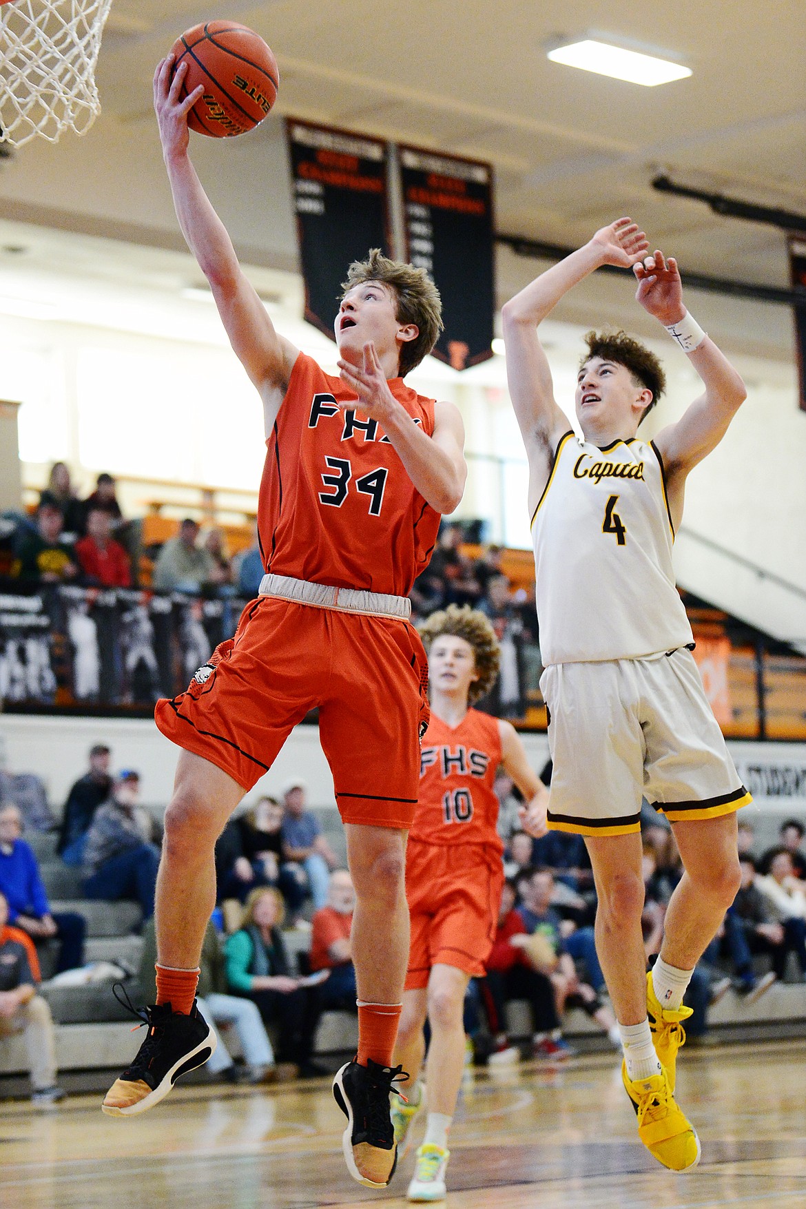 Flathead&#146;s Joston Cripe (34) scores on a fastbreak layup ahead of Helena Capital&#146;s Brayden Koch (4) at Flathead High School on Saturday. (Casey Kreider/Daily Inter Lake)