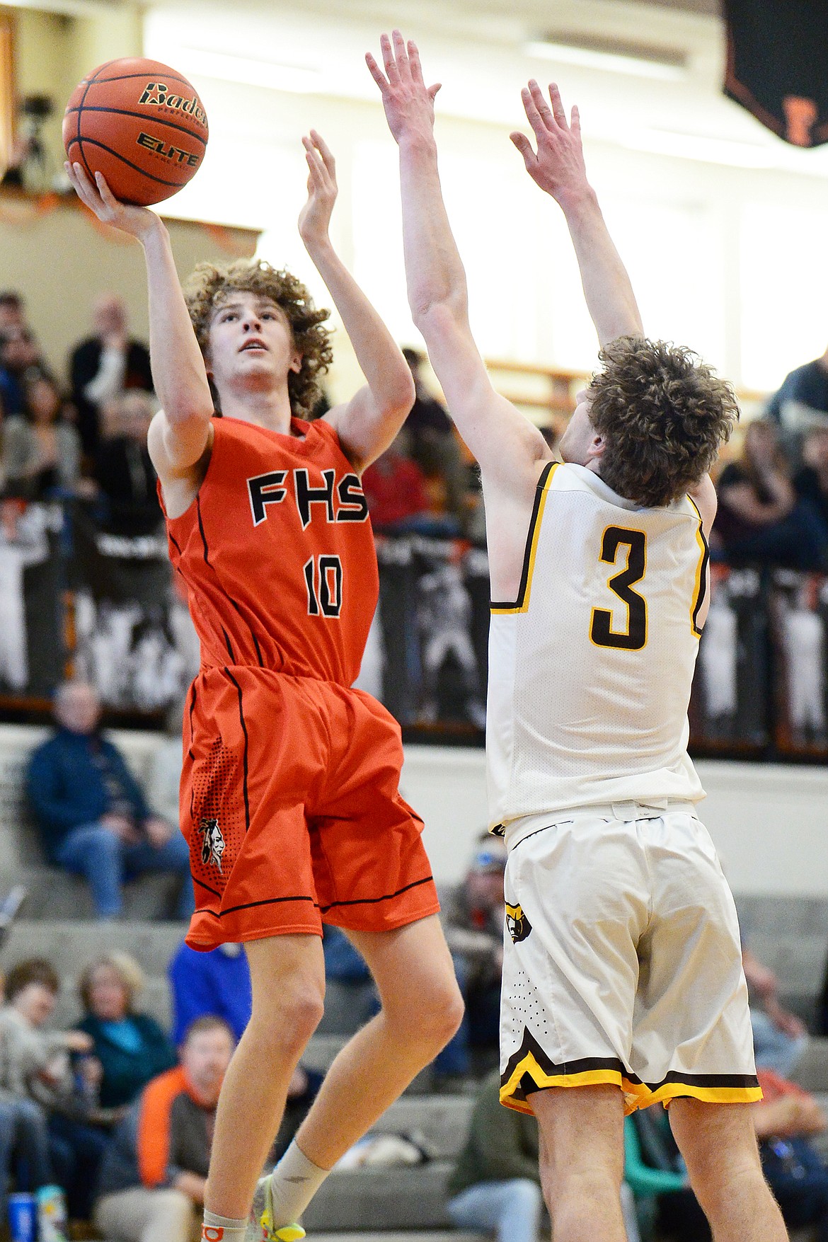 Flathead's Hunter Hickey (10) looks to shoot over Helena Capital's Ryan Quinn (3) at Flathead High School on Saturday. (Casey Kreider/Daily Inter Lake)