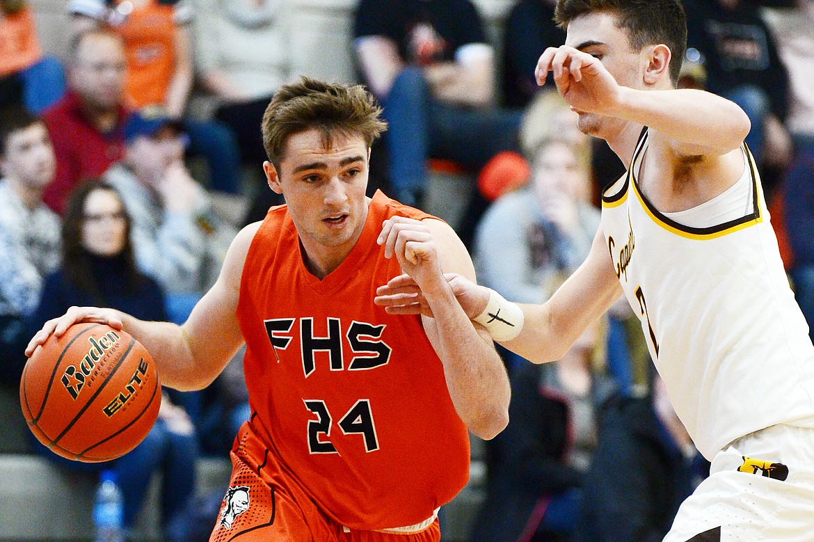 Flathead&#146;s Gatlin Bruner (24) drives to the hoop against Helena Capital&#146;s Parker Johnston (2) at Flathead High School on Saturday. (Casey Kreider/Daily Inter Lake)