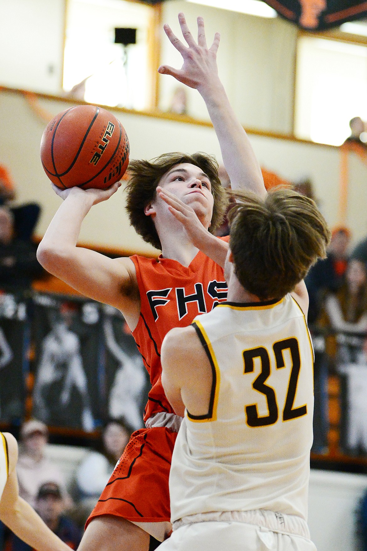 Flathead's Tannen Beyl (5) drives to the hoop against Helena Capital's Shane Haller (32) at Flathead High School on Saturday. (Casey Kreider/Daily Inter Lake)