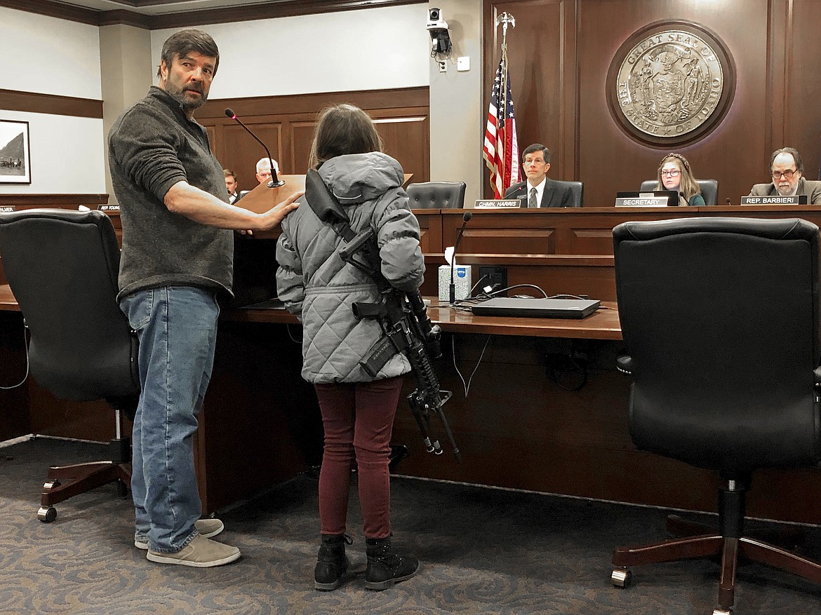 (AP Photo/Keith Ridler)
Charles Nielsen, 58, and his 11-year-old granddaughter, Bailey Nielsen, testify before a House panel at the Idaho Statehouse on Monday. Feb. 24,  in Boise. Visitors to Idaho 18 and older who can legally possess firearms would be allowed to carry a concealed handgun within city limits under legislation that headed to the House on Monday, Feb. 24.