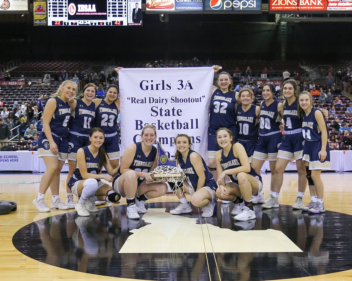 Photo by JASON DUCHOW PHOTOGRAPHY
Timberlake High&#146;s girls basketball team poses with the trophy and the banner after defeating Snake River 42-32 in the championship game of the state 3A girls basketball tournament Saturday afternoon at the Ford Idaho Center in Nampa. It was Timberlake&#146;s third state title in the last five years.