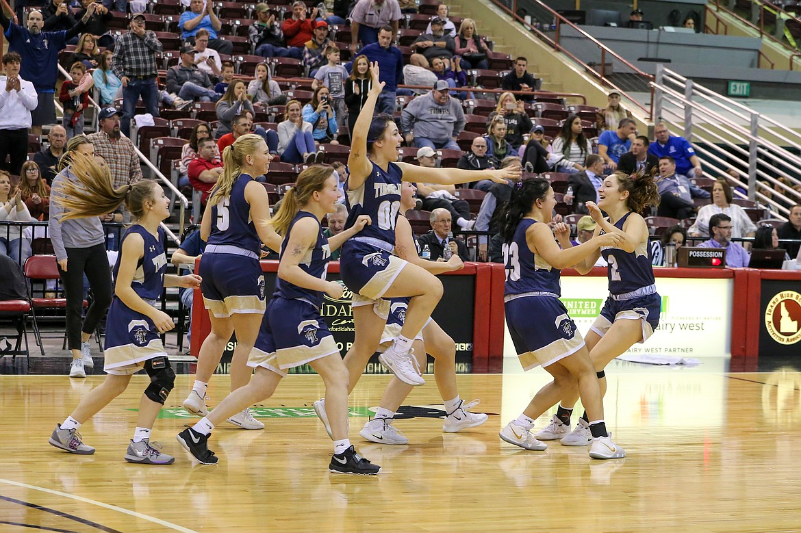 Photo by JASON DUCHOW PHOTOGRAPHY
Timberlake players rush the floor to greet Taylor Suko (2) after the Tigers beat Snake River in the state 3A girls championship game Saturday at the Ford Idaho Center in Nampa.