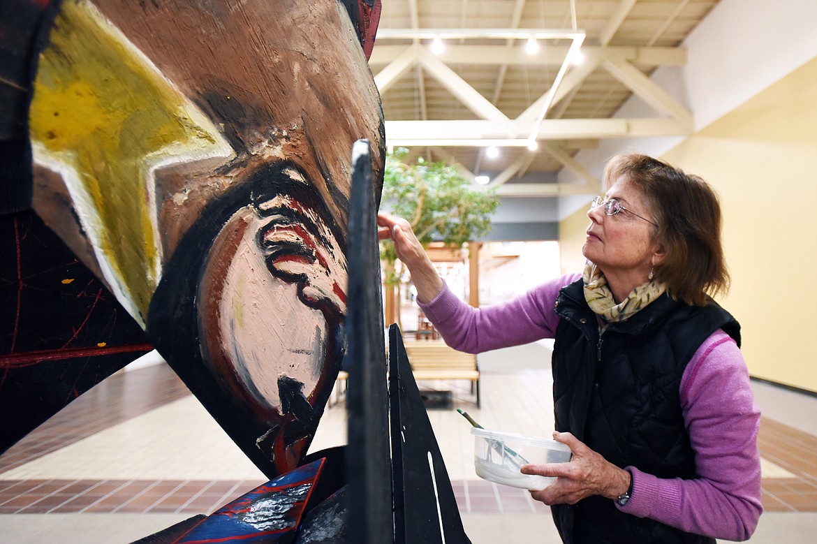 Artist Jennifer Thompson works on her piece titled &#147;Aspects of the Broken Heart&#148; at Gateway Community Center in Kalispell on Friday. (Casey Kreider/Daily Inter Lake)