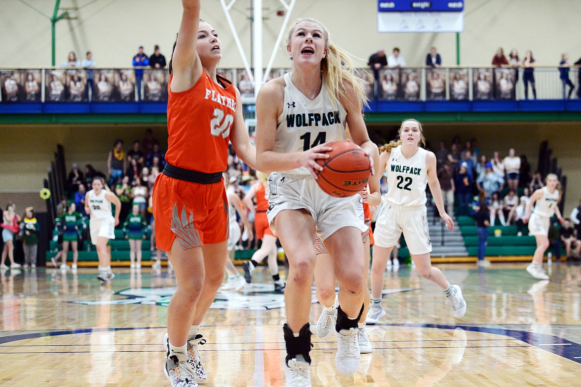 Glacier's Aubrie Rademacher (14) drives to the basket against Flathead's Bridget Crowley (20) during a crosstown matchup at Glacier High School on Friday. (Casey Kreider/Daily Inter Lake)