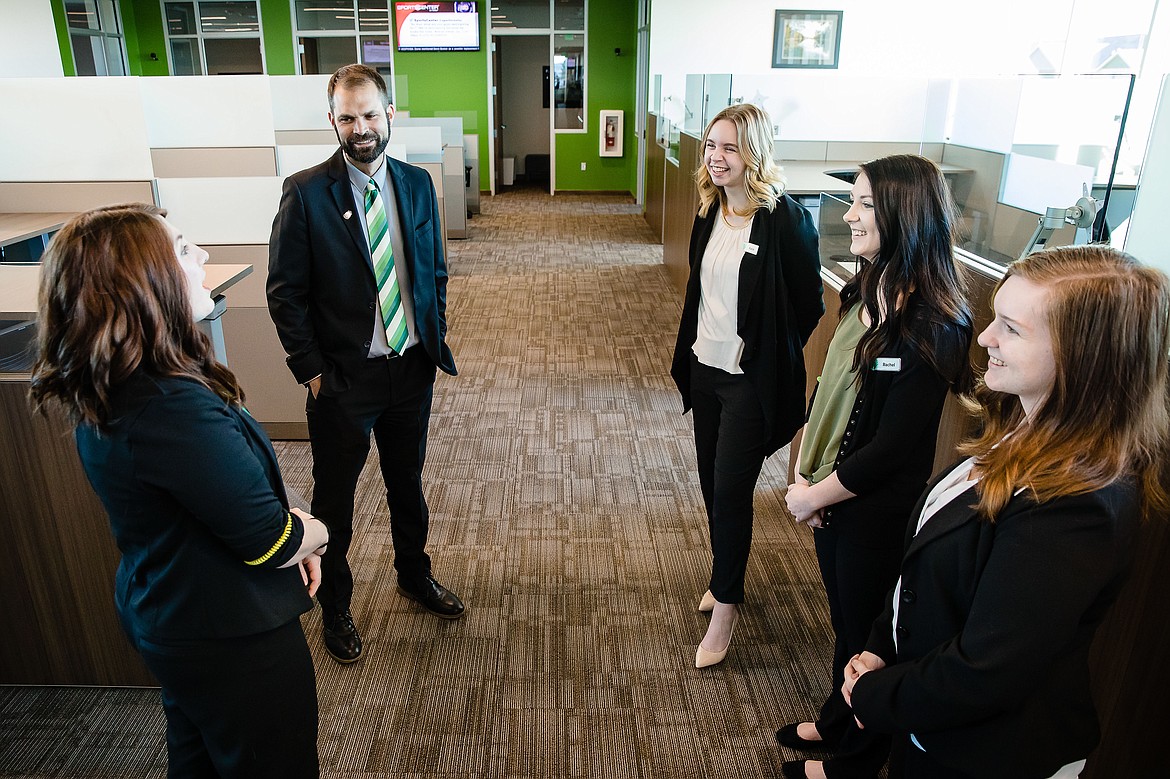 Michael Wolsten, vice president of ICCU&#146;s new Coeur d&#146;Alene branch, talks with member service specialists Kelsey Mapston, left, Kacie Dean, Rachel Souza and Crystal Knight in the soon-to-be opened call center in the new ICCU branch.