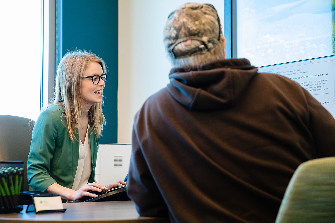 Jenn Wilhelm, member service specialist at ICCU&#146;s new Coeur d&#146;Alene branch, works with a new member.