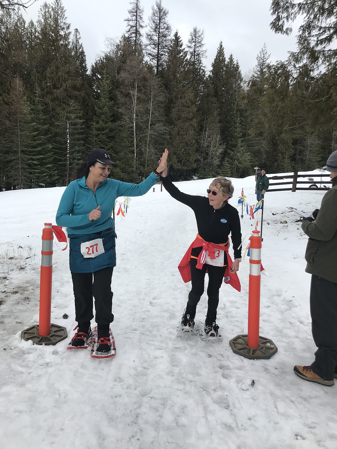 (Photo courtesy)
Pam Hewitt (left) and Carol Wright high five after finishing the women's 10K race at the Western Pleasure Snowshoe Roundup. Wright is 77 years old and will be running her fifth Boston Marathon in April.