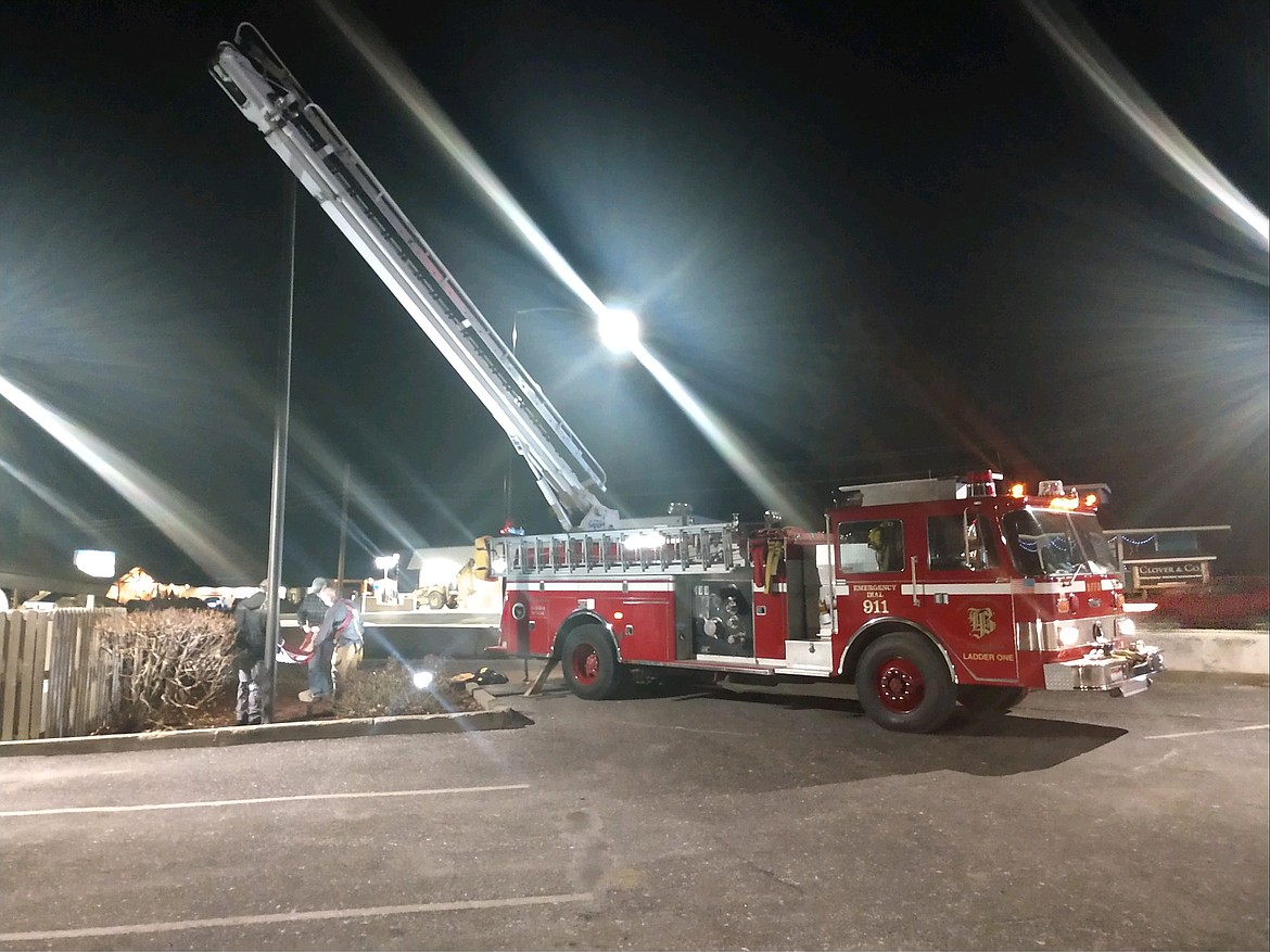 Courtesy photo
Bonners Ferry Firefighters fold the U.S. flag after rescuing it from the top of the flagpole at Wells Fargo Bank. It was seen dangling in the wind.