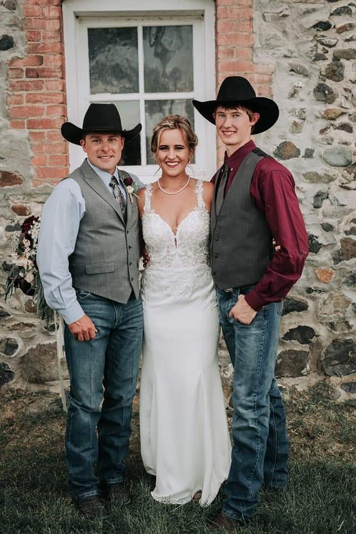 Payton and Katelynn Fitzpatrick pose for a photo with officiator and professional bullfighter, Kaleb Barrett,  on their wedding day at Kleffner Ranch in East Helena last September. (MKate Photography photo)