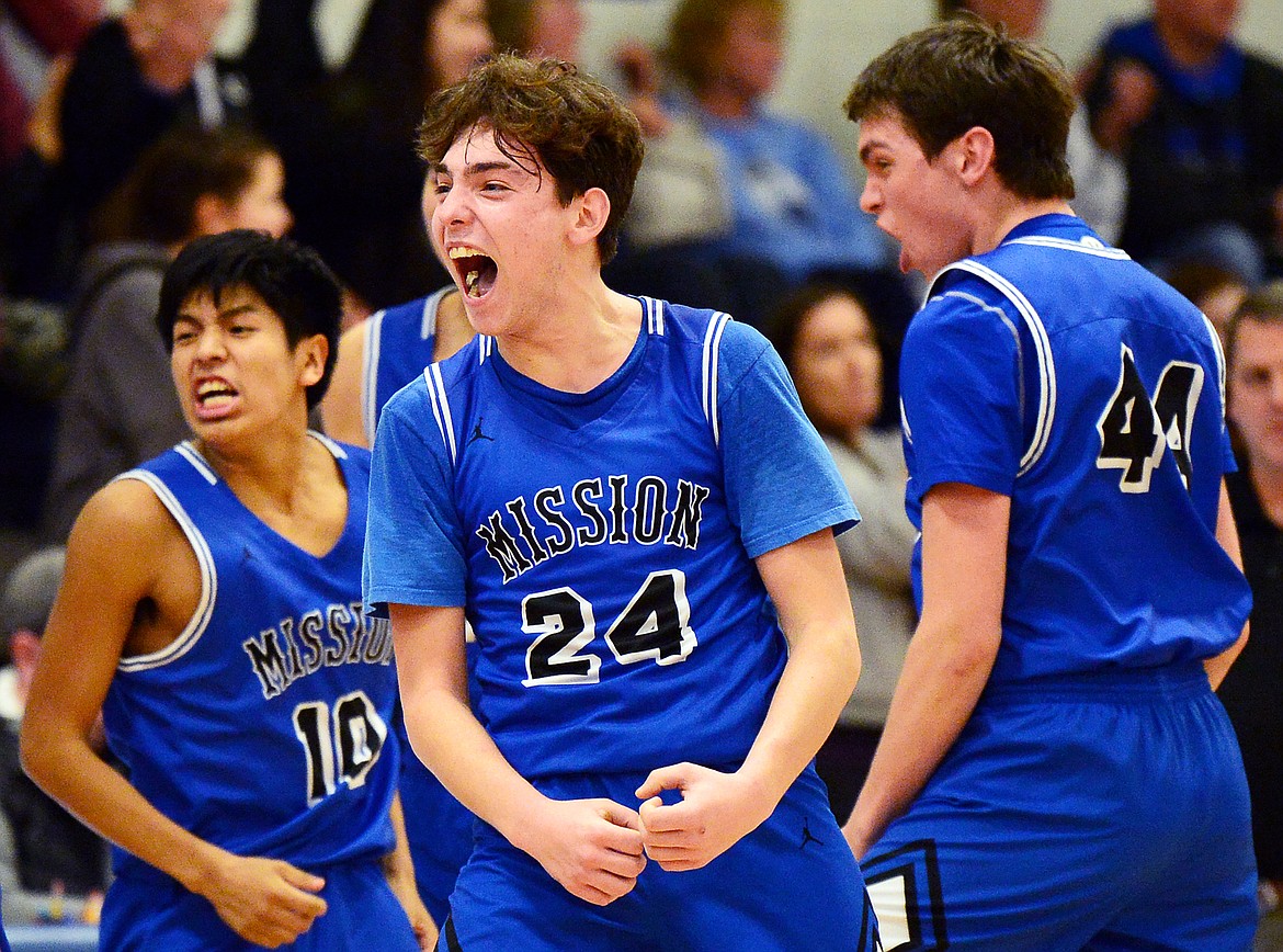 Mission's Isaiah Nasewytewa (10), Jedi Christy (24) and Hayden Currie (44) celebrate after a 47-44 win over Bigfork at Bigfork High School on Thursday. (Casey Kreider/Daily Inter Lake)