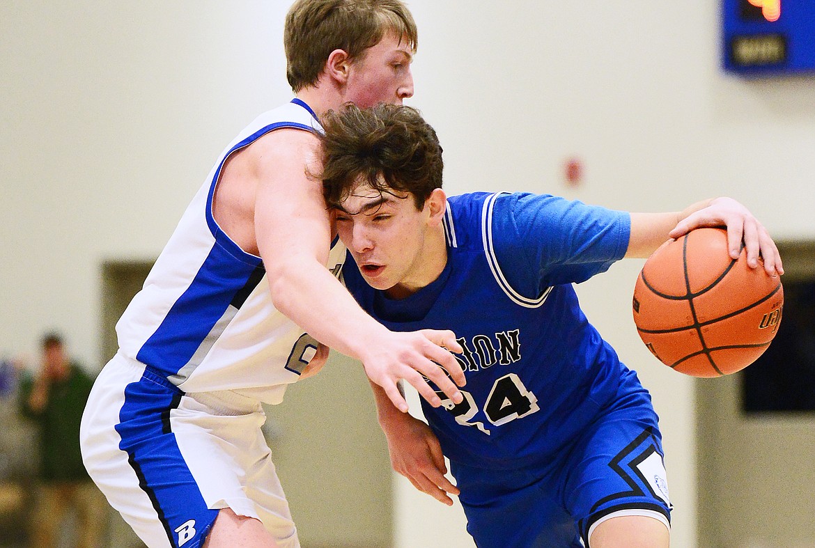 Mission's Jedi Christy (24) drives to the basket against Bigfork's Isaac Bjorge (23) at Bigfork High School on Thursday. (Casey Kreider/Daily Inter Lake)