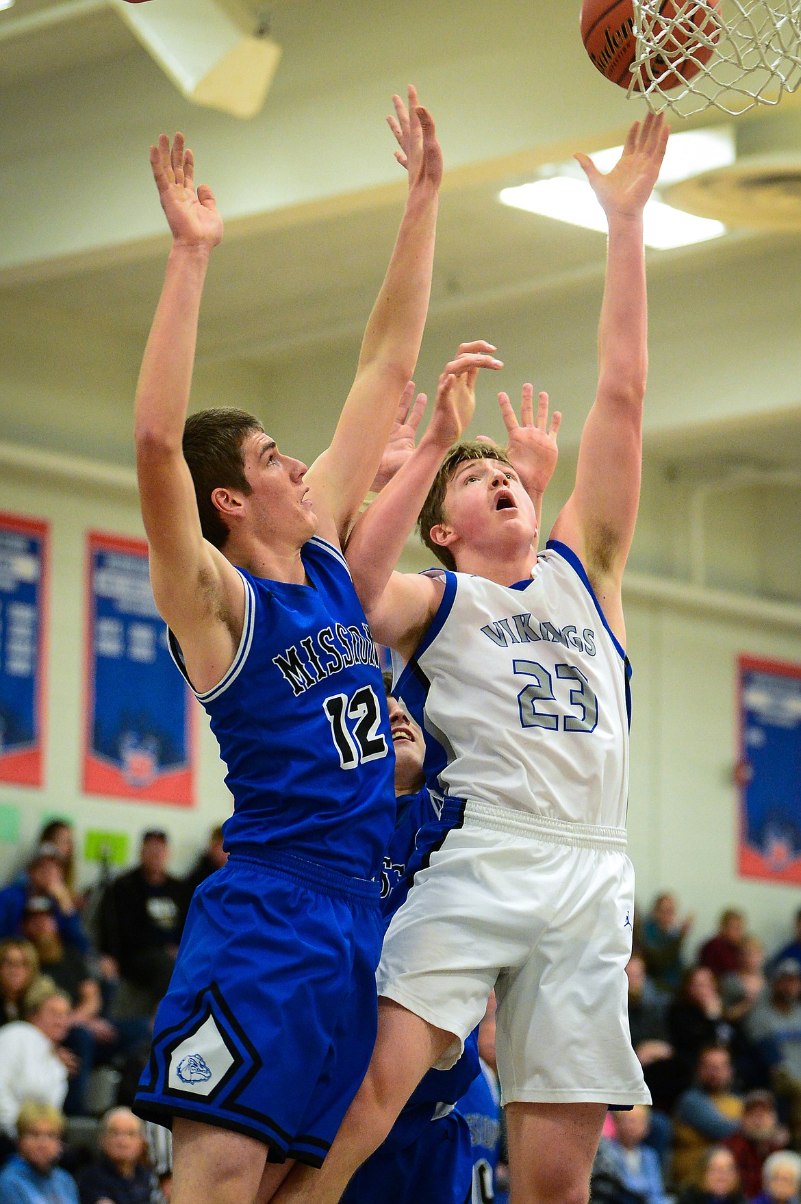 Bigfork&#146;s Isaac Bjorge (23) shoots against St. Ignatius&#146; Ross McPherson (12) at Bigfork High School on Thursday. (Casey Kreider/Daily Inter Lake)