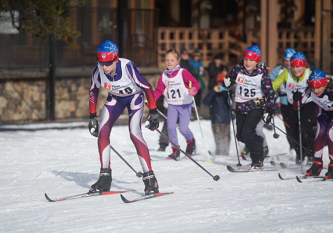 Top, racers in the 4k race hit the final turn before the finish line. Above, a pack of racers look to spread apart after leaving the start line. (Daniel McKay/Whitefish Pilot)