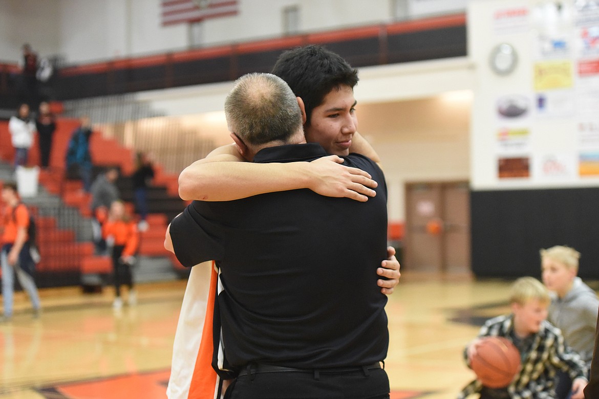 Ronan senior Trey Don't Mix hugs his coach Ron Couture last Thursday after the Chiefs beat Corvallis 47-44 at home on senior night. (Whitney England/Lake County Leader)