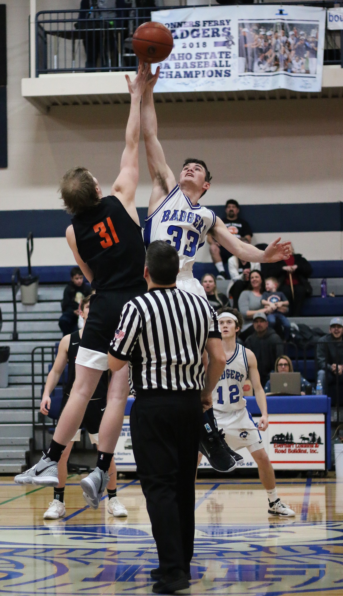 Photo by MANDI BATEMAN 
Braeden Blackmore jumping high for the tip off.