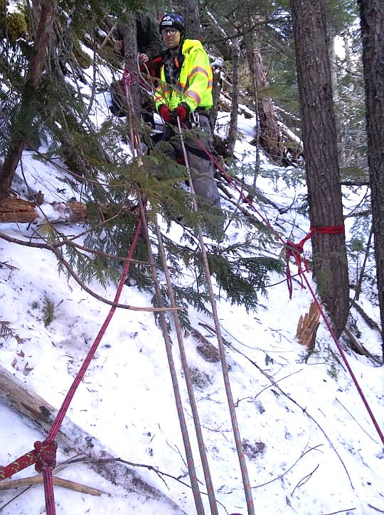 Photo by GARRY WRIGHT 
Hall Mountain Firefighter, Matt Cossalman, with the ropes set up to rescue the stranded dog.