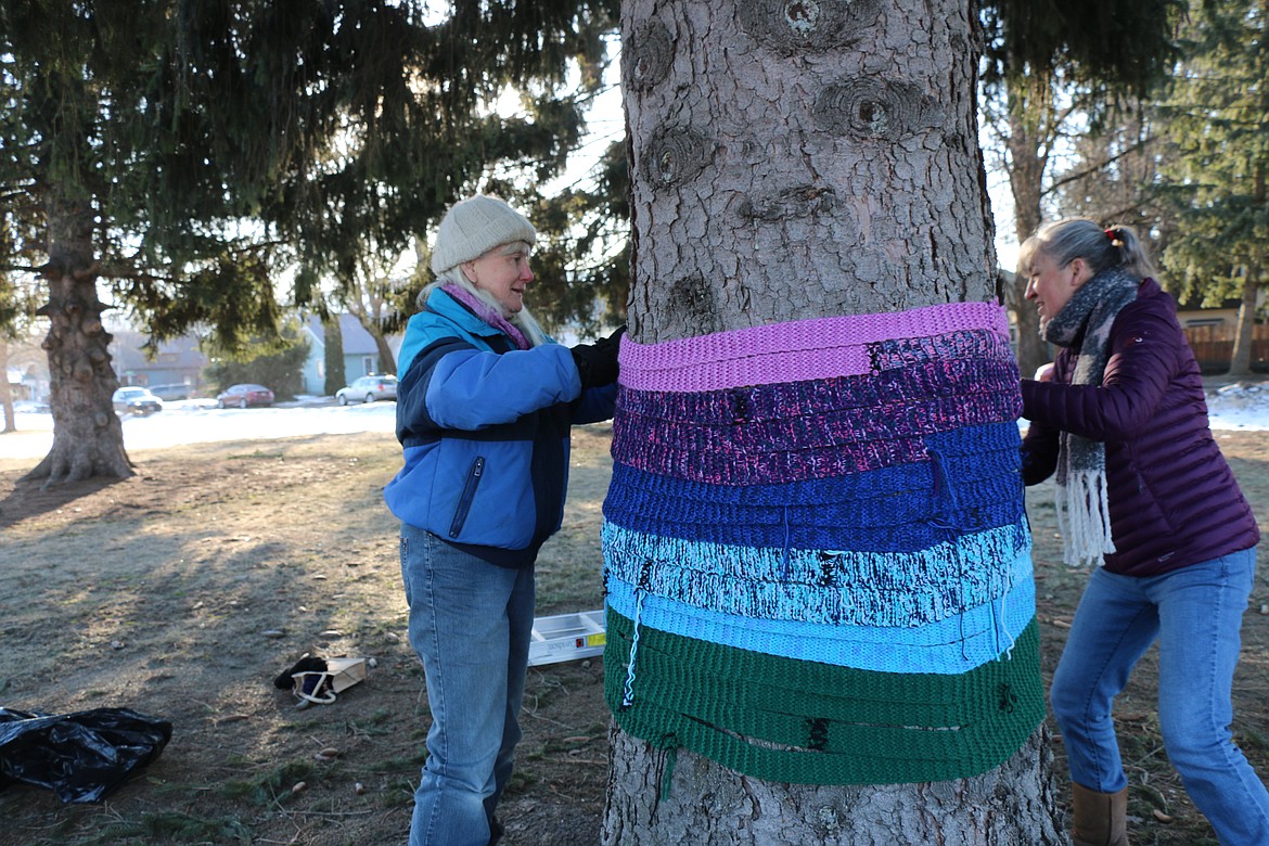 (Photo by CAROLINE LOBSINGER)Members of a Sandpoint area knitting group reinstall their art bombing display early Wednesday morning.